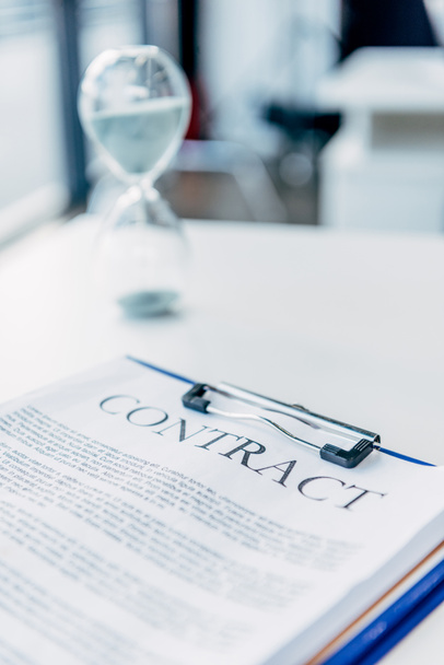 close-up shot of clipboard with contract on white desk at office - Foto, Bild