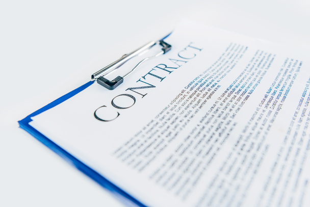 close-up shot of clipboard with contract on white tabletop - Foto, imagen