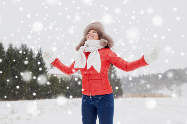 happy woman in winter fur hat having fun outdoors - Фото, изображение