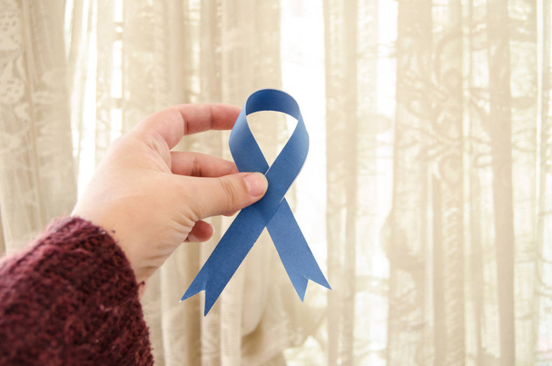woman hand holding blue ribbon, blue november prostate cancer awareness month conceot - Photo, Image