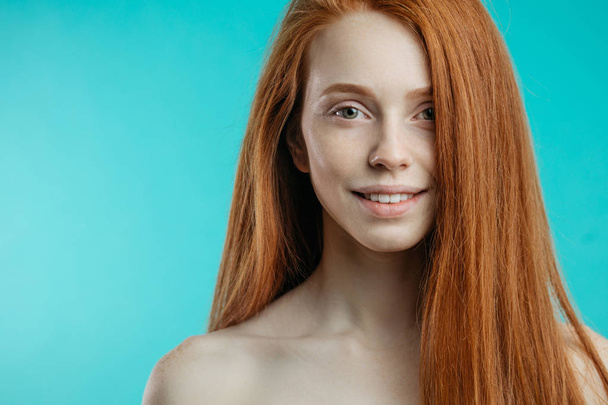Female model with red loose hair and natural make-up posing over - Fotografie, Obrázek