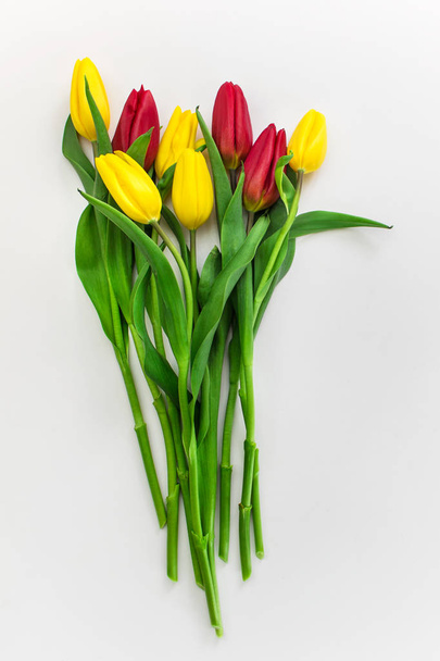 Bouquet of yellow and red tulips on white background. - Fotografie, Obrázek
