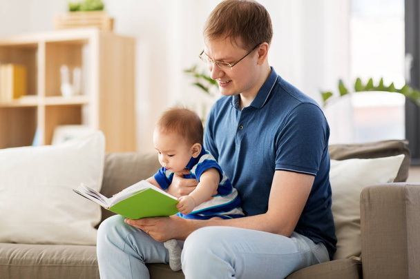 happy father and little baby son with book at home - Valokuva, kuva