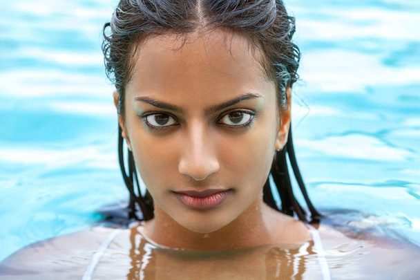 Portrait of beautiful sexy young Indian Asian woman or girl wearing bikini in swimming pool - Foto, immagini