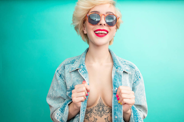 Sexual woman in denim jacket with tattoo under breast. Rock Star - Valokuva, kuva