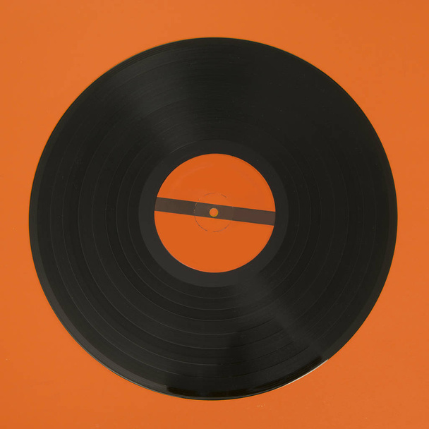 Black vinyl record on a yellow background - Photo, Image
