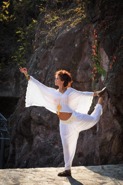 young woman practice yoga outdoor autumn day doing balance pose  full body shot - Fotoğraf, Görsel