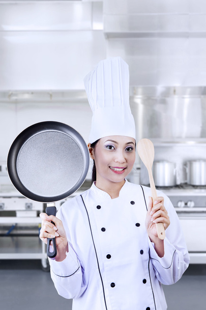 Chef holding pan and wooden spoon - Foto, Imagem