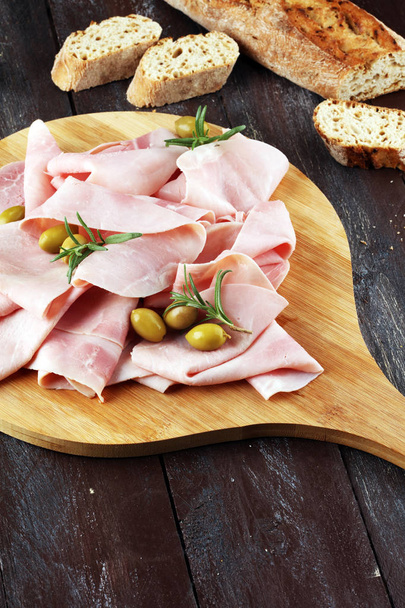 Sliced ham on wooden background. Fresh prosciutto. Pork ham sliced. - Photo, Image