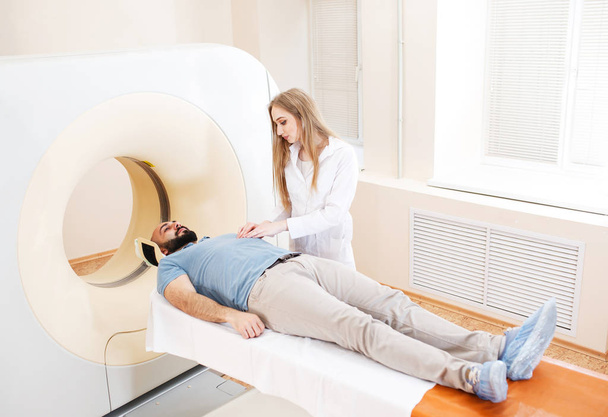 Happy patient undergoing mri scan at hospital. - Photo, Image