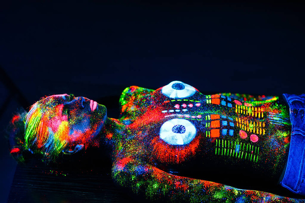 Concept. On the body of a girl painted DJ deck. Half-naked girl painted in UV colors. - Fotoğraf, Görsel