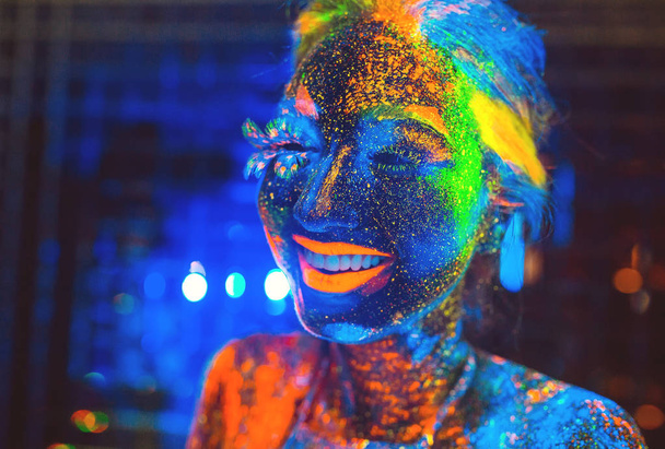 Portrait of a girl painted in fluorescent powder. - Fotó, kép