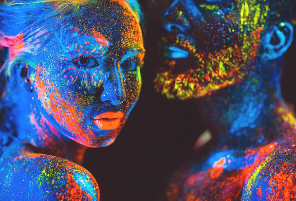 Portrait of a pair of lovers painted in fluorescent powder. - Φωτογραφία, εικόνα
