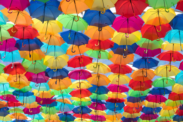 Lots of umbrellas coloring the sky in the city of Agueda, Portugal - Photo, Image