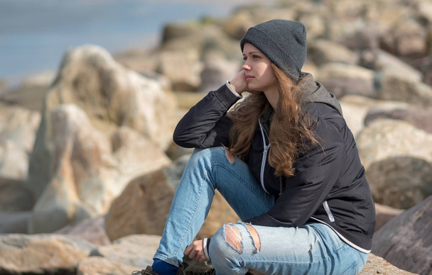 Young 20 year old girl relaxes at the west coast of Ireland - 写真・画像