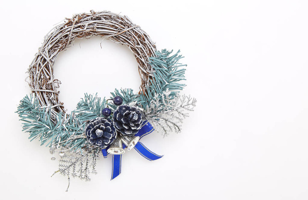 Green and blue christmas wreath with decorations on the white wall - Photo, Image