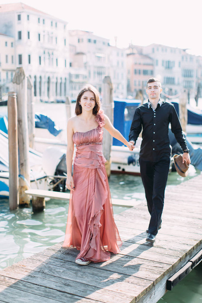 Romantic young couple posing on bridge over canal during honeymoon in Venice  - Valokuva, kuva
