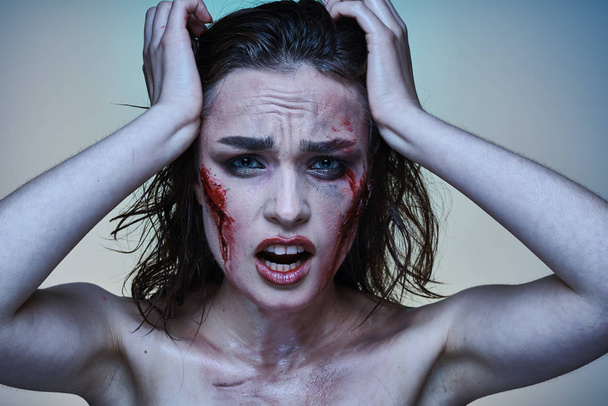 Beautiful girl with a wounded face in the blood - Photo, Image