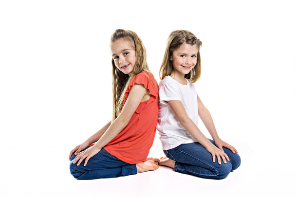 Portrait of two cute friends 7 years old girl Isolated over white background - Fotó, kép