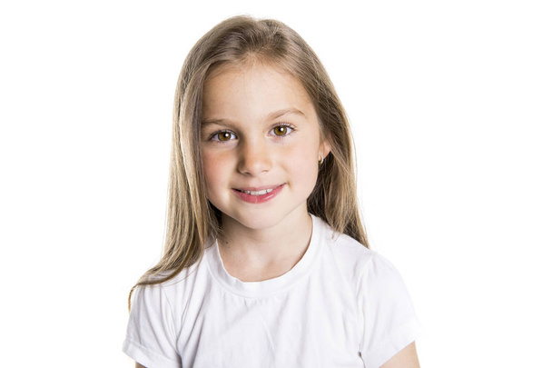 Portrait of a cute 7 years old girl Isolated over white background - 写真・画像