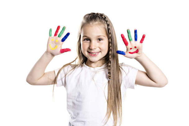 smiling girl with the palms painted by a paint. Isolated on white background - Фото, изображение