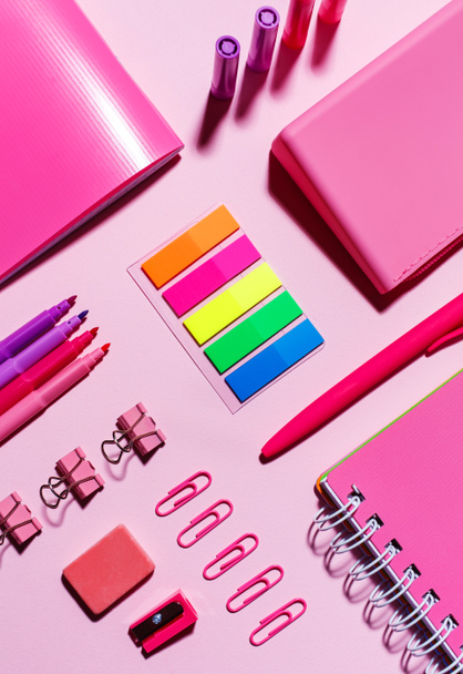 Color stickers, pink notebooks, paper clips, markers, elastic band and sharpener - Foto, imagen