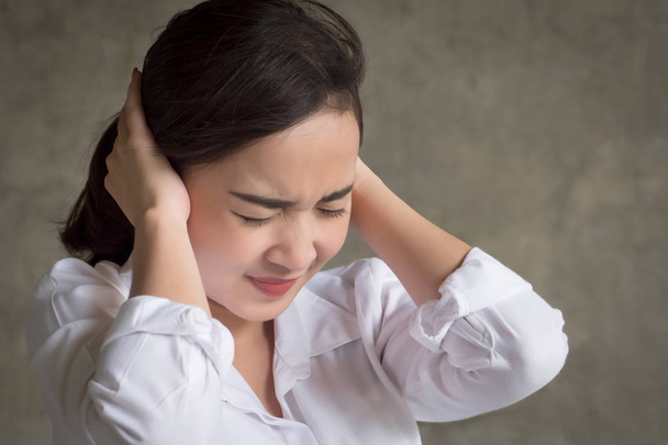 stressed woman covering, closing her ear not to hear bad news; portrait of sad, unhappy asian woman covering her both ears, concept of problem, trouble, frustration; asian young adult woman model - Photo, Image