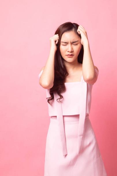 Young Asian woman got sick and  headache on pink background - Фото, изображение