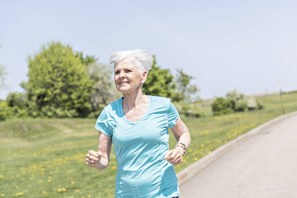 Senior Woman Jogging In Park - Foto, imagen