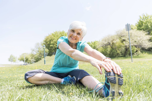 Senior Woman stretching In Park - Фото, зображення