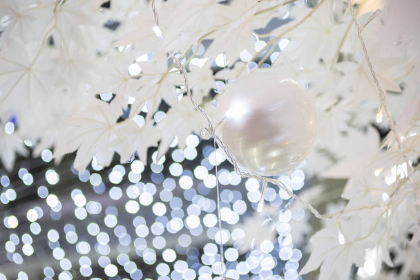 decorative festive christmas bauble on blurred sparkling holiday background - Photo, Image