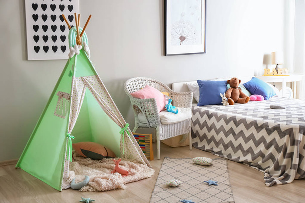 Cozy play tent for kids in interior of room - Фото, изображение