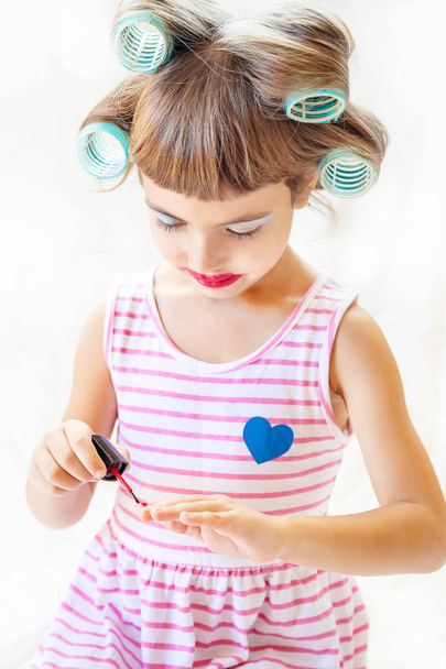 little fashion-girl. girl does her make up and manicure. selective focus. Children. - Foto, Imagem