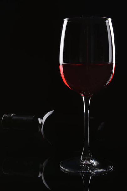 Glass of red wine on dark background - Фото, зображення