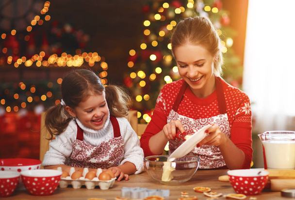 happy funny mother and child  bake christmas cookie - Zdjęcie, obraz