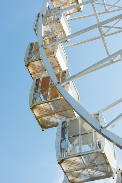 cabins of observation wheel against blue sky in amusement park - Photo, Image