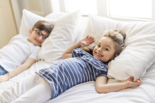 Brother And Sister having fun Together on Bed - 写真・画像