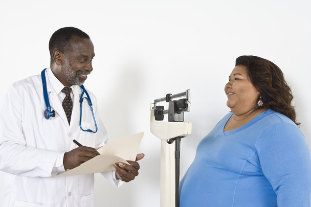 Doctor Examining Patient's Weight - Фото, изображение