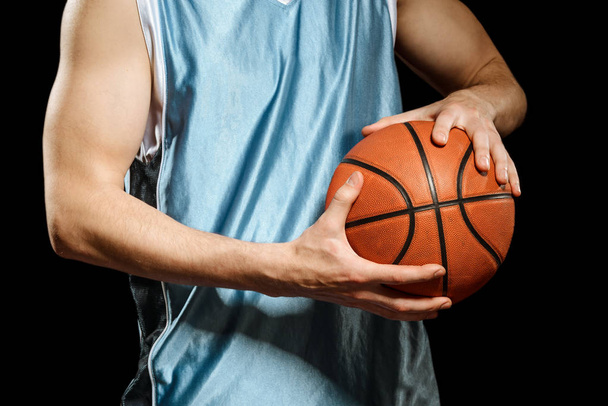 Basketball player holding a ball - Foto, imagen