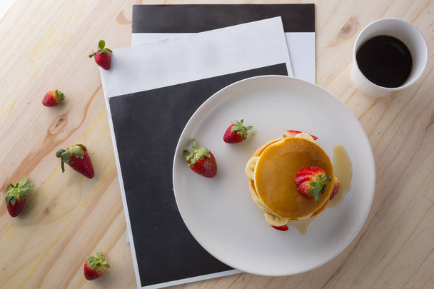 Appetizing pancakes with strawberries, bananas and honey on white plate - Valokuva, kuva