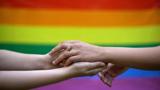 Lesbian wedding, rainbow flag on background, same-sex marriage, minority rights - 写真・画像