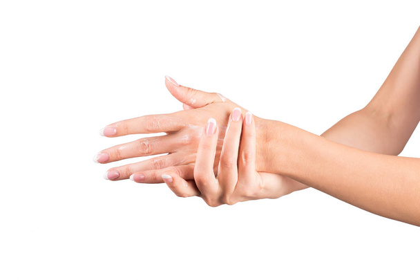 Female hands applying hand cream, white background, closeup - Fotografie, Obrázek