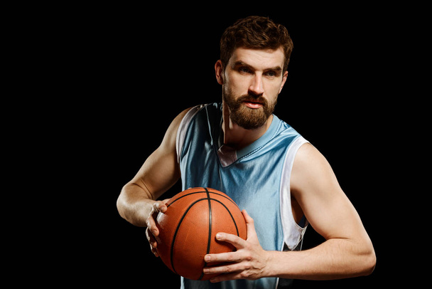 Man posing with a basketball - Фото, изображение