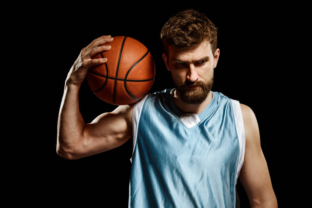 Muscular basketball player on black - Фото, зображення