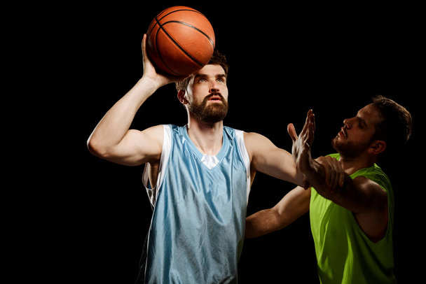 Athletic men playing basketball - Фото, зображення