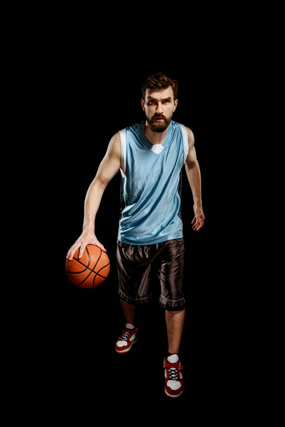Basketball player holding a ball - Foto, afbeelding