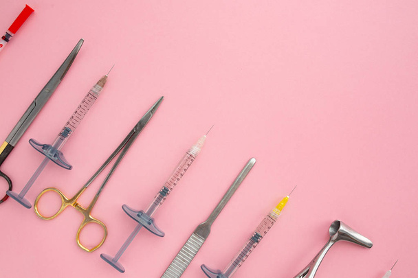 Flat lay of medical instruments on rose background. Mock up health care medical background. - Foto, afbeelding