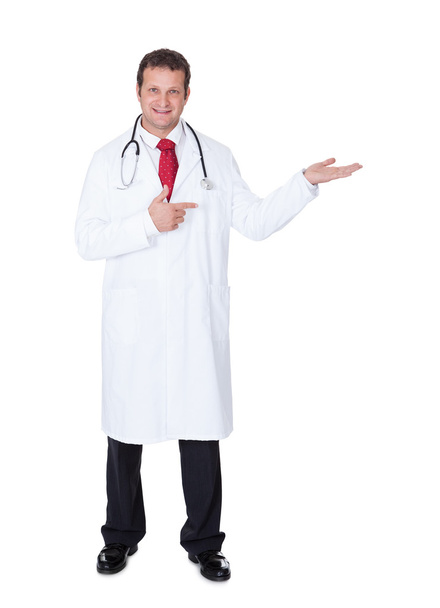 Confident doctor presenting empty space - Photo, image