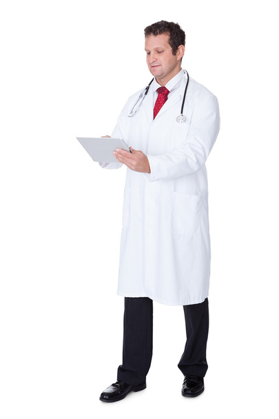Confident doctor using tablet - Foto, afbeelding