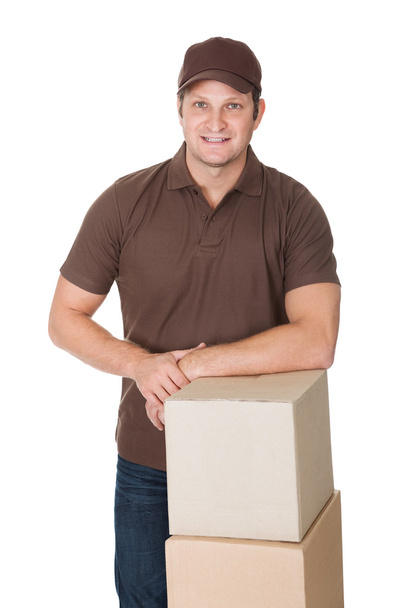 Portrait of delivery man with stack of boxes - Φωτογραφία, εικόνα